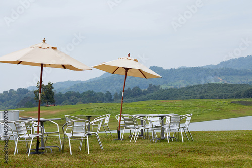 Close-up of outdoor leisure tables and chairs by the lake in the outdoor grass