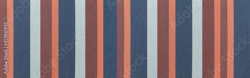 Panorama of Fabric texture with multi-colored stripes. Colored embroidery pattern and background seamless