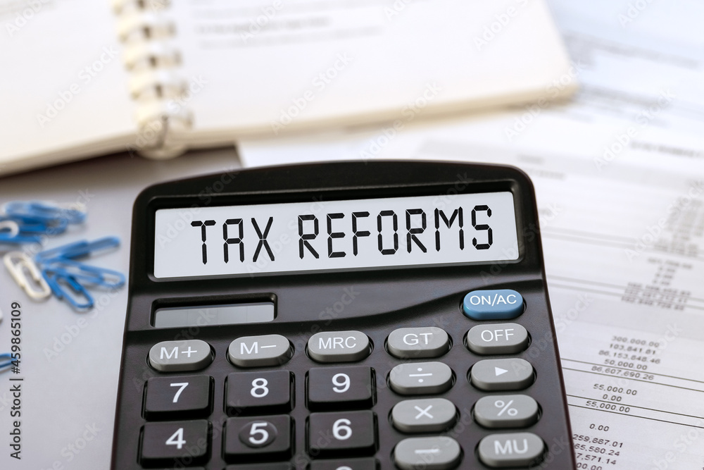 Tax Reforms - concept of text on calculator display Tax Reforms - concept of text on calculator display