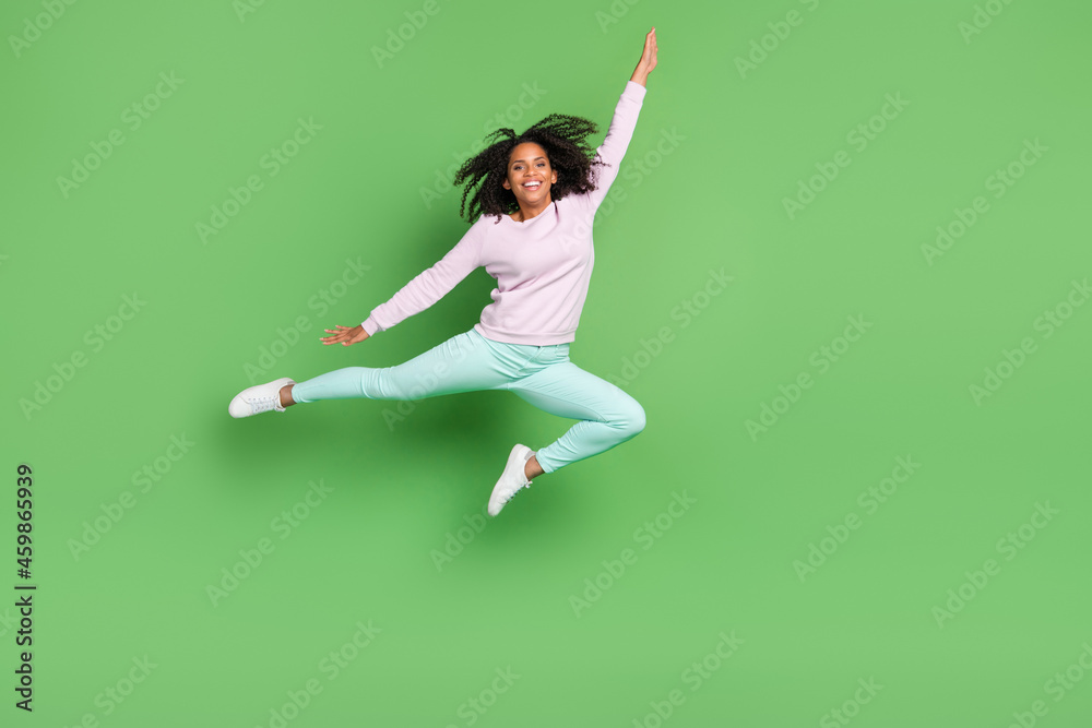 Full body photo of funky millennial brunette lady jump wear pullover pants shoes isolated on blue background