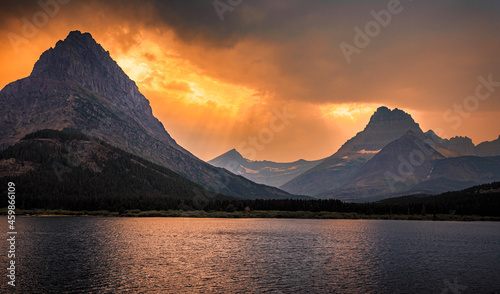 Swiftcurrent Lake and Mountain Fire Sky Sunset at Many Glacier, Glacier National Park, Montana photo