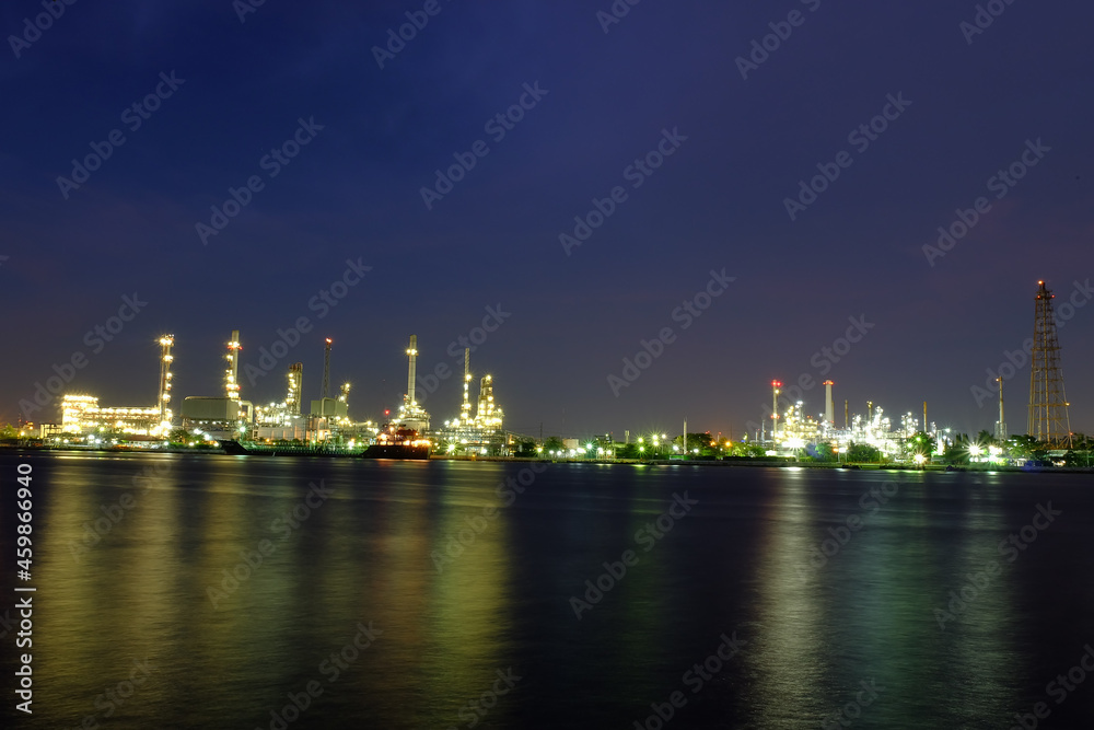 Oil refinery river front at night