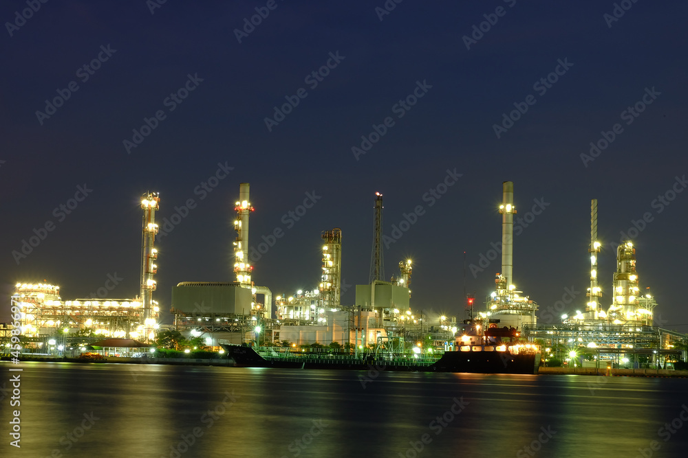 Oil refinery river front at night