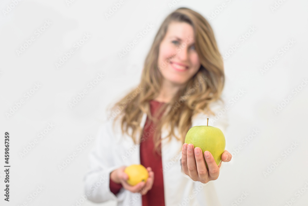 pretty Caucasian girl holding an apple . Nutritionist advising on healthy food pretty Caucasian girl holding an apple . Nutritionist advising on healthy food