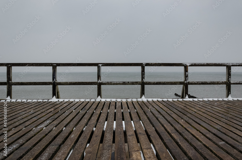 SEA COAST IN WINTER - Snowstorm on the wooden pier