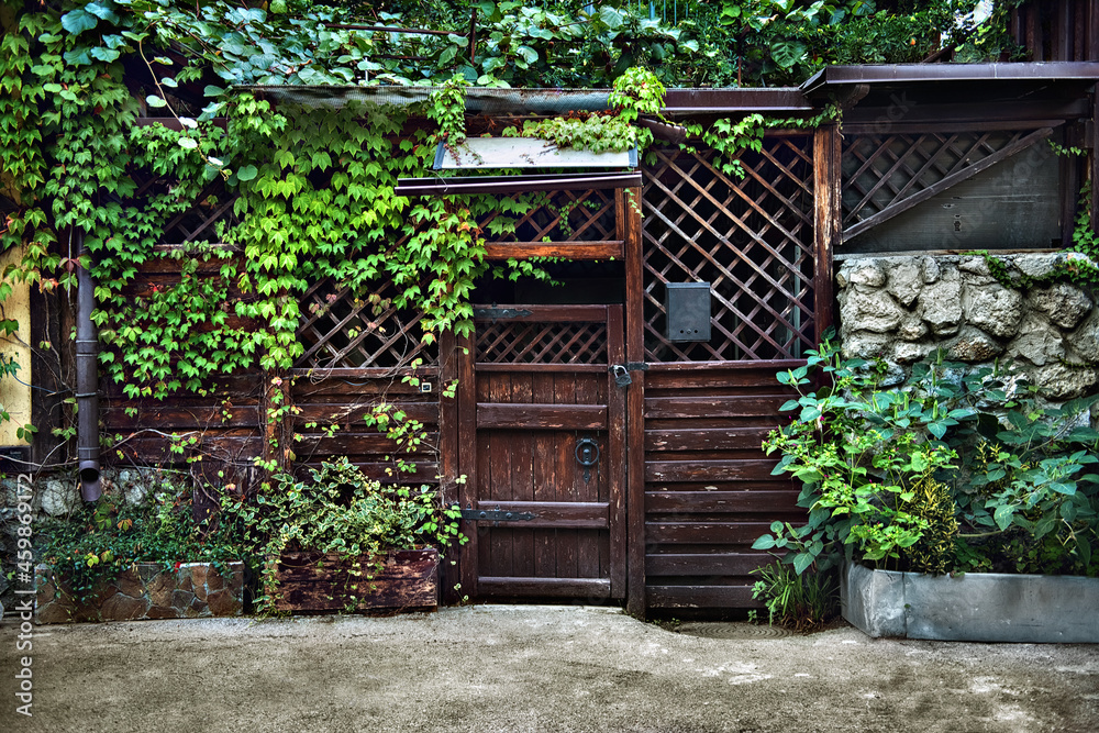 wooden gate to enter the old courtyard from the street wooden gate to enter the old courtyard from the street