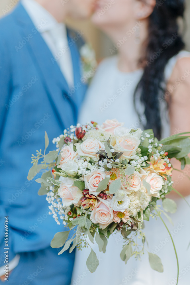 Bride in wedding dress and large train stands next to the groom. Classical wedding Bride in wedding dress and large train stands next to the groom. Classical wedding