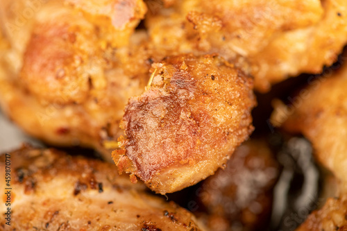 Fried pieces of meat in a frying pan, close-up, selective focus.