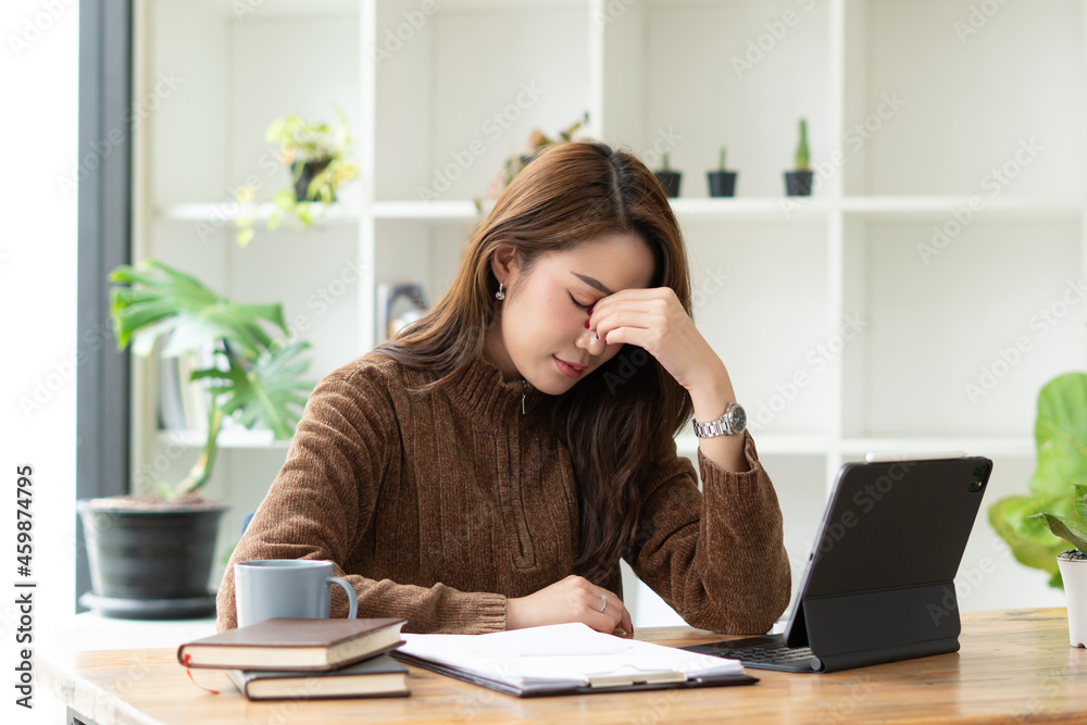 Stressful Asian businesswoman working in office tired and bored. Stressful Asian businesswoman working in office tired and bored.