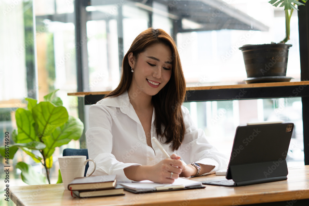 Portrait Of Attractive Asian Businesswoman Working On Laptop for marketing plan Portrait Of Attractive Asian Businesswoman Working On Laptop for marketing plan