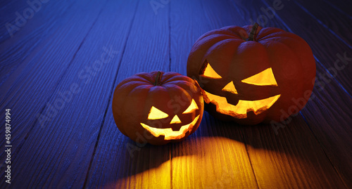 3D illustration Two spooky halloween pumpkins, Jack O Lantern on a wooden table