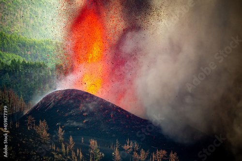 Fototapeta Volcano eruption near forest in nature