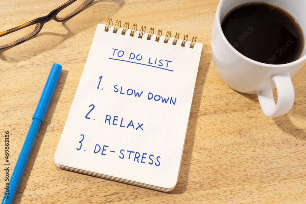 De-stress relax concept. To do list on notepad on desk De-stress relax concept. To do list on notepad on desk