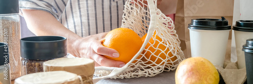 Food delivery home.Contactless delivery service.Online order and payment.Store services in food delivery in quarantine covid.Girl in the kitchen arranges food Zero waste photo