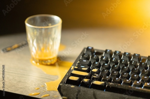 Coffee spilled on mechanical keyboard of computer photo