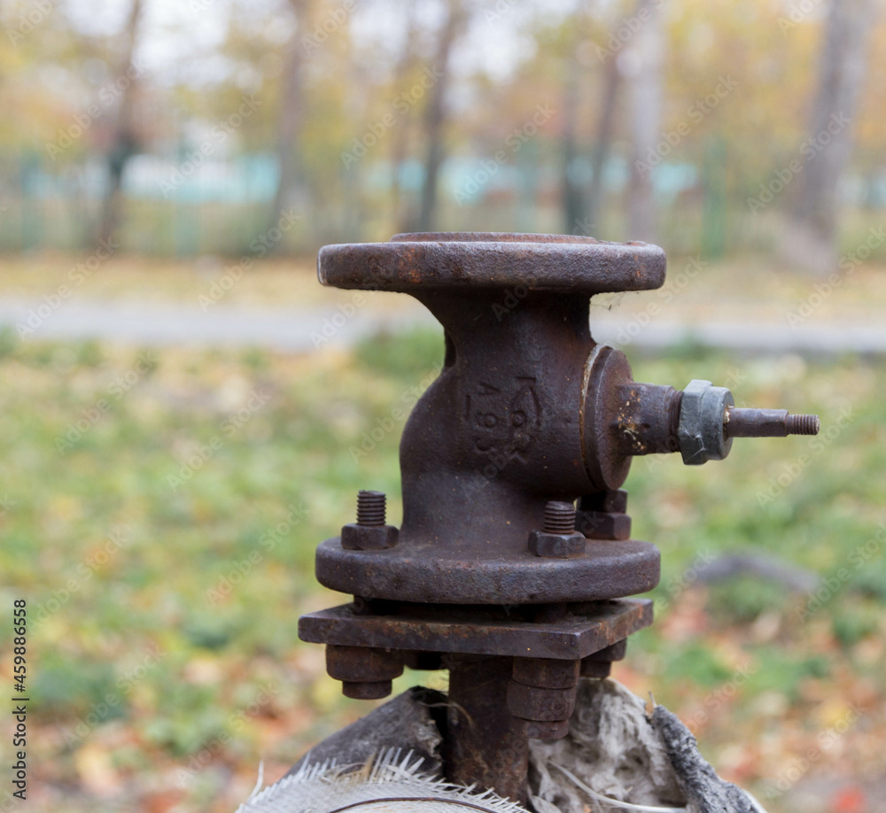 a large fan valve old rusty is located on the heating main