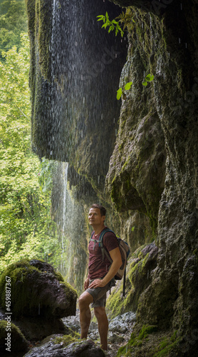 Adult man hiking at Sipote waterfall  Transylvania region  Romania  Europe