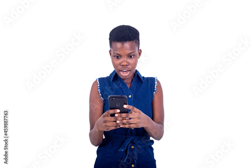 beautiful surprised young woman looking at bad news on mobile phone screen.