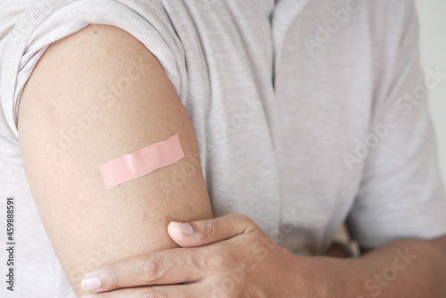 adhesive bandage on young man's arm 