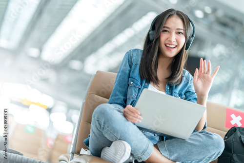 Photography attractive asian female traveller wear casula cloth headphone using laptop for w
