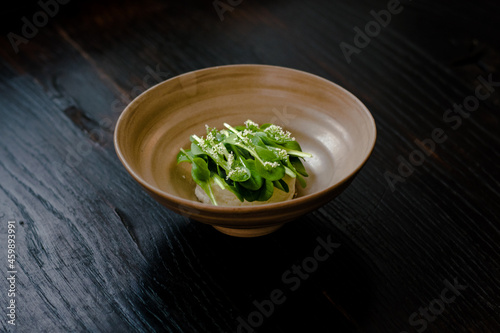 Dish of cottage cheese and garden greens with flowers made at a restaurant