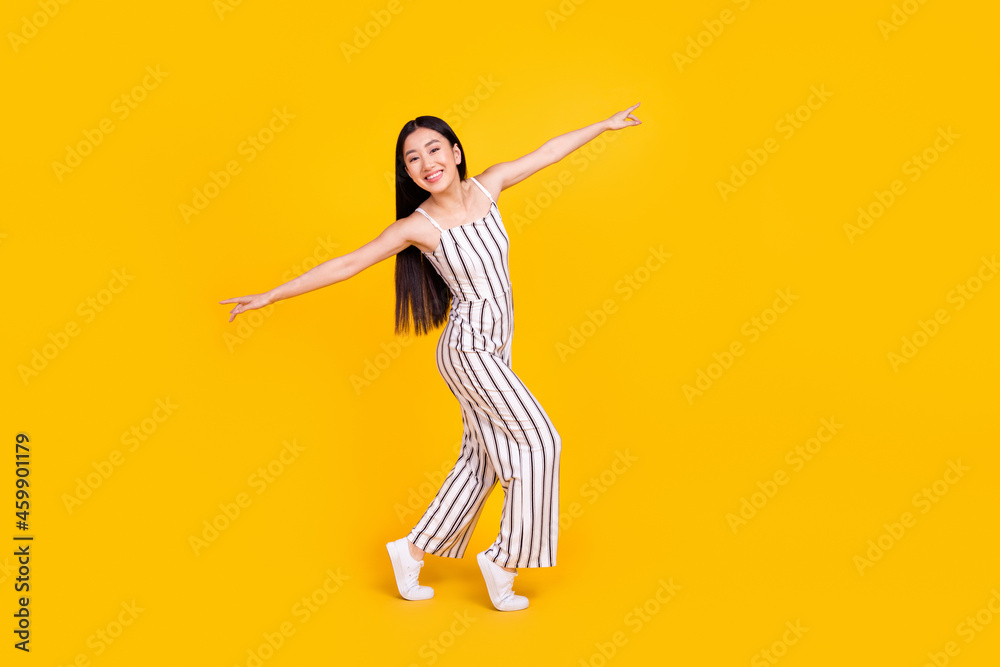 Full length body size photo woman smiling dancing at party wearing casual overall isolated bright yellow color background Full length body size photo woman smiling dancing at party wearing casual overall isolated bright yellow color background