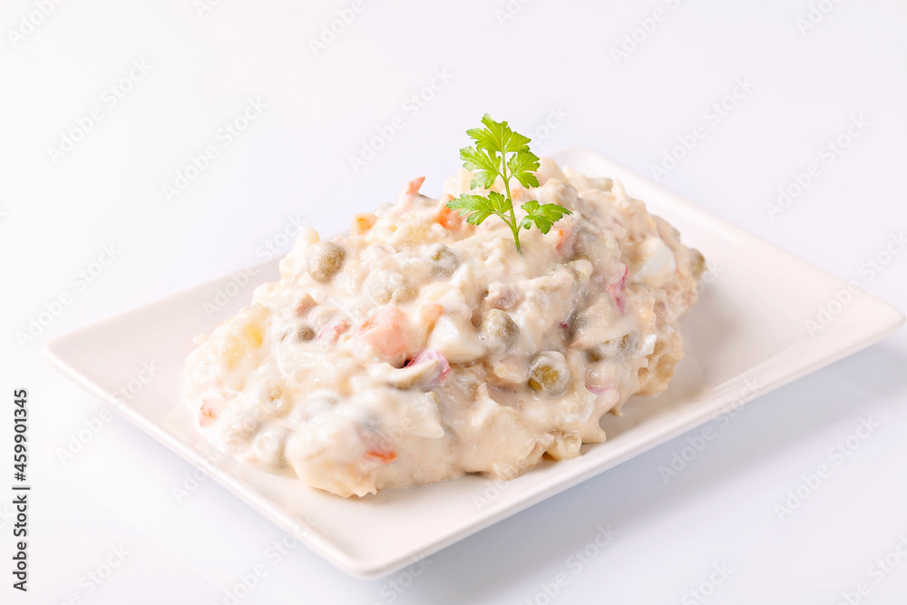 Ensaladilla rusa, potato salad with mayonnaise on white background Ensaladilla rusa, potato salad with mayonnaise on white background