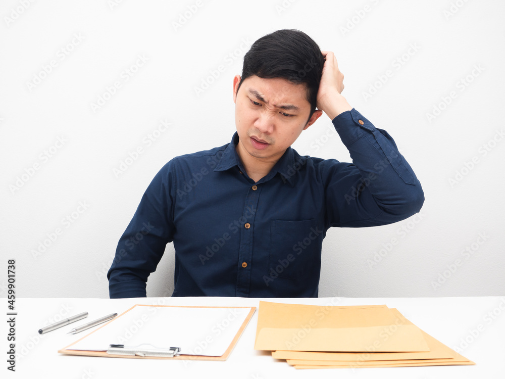 Man feeling headache about many document envolope on table white background Man feeling headache about many document envolope on table white background