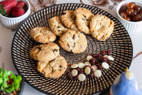 Vegetarian cranberry cookies. Fresh white chocolate cookies on plate. Eggless home baked cookies.