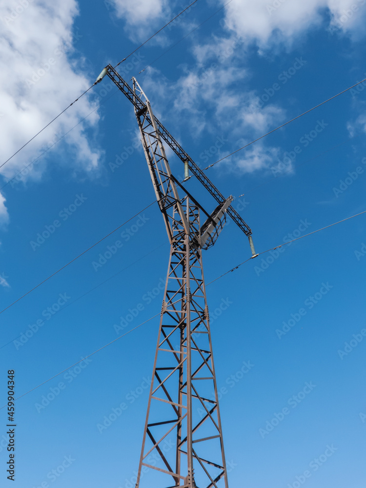 High-voltage tower with blue sky background.