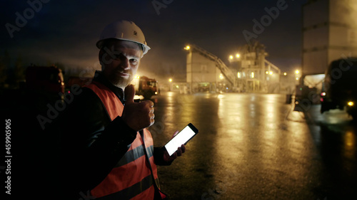 Engineer with tablet computer look at camera showing thumbup outdoors