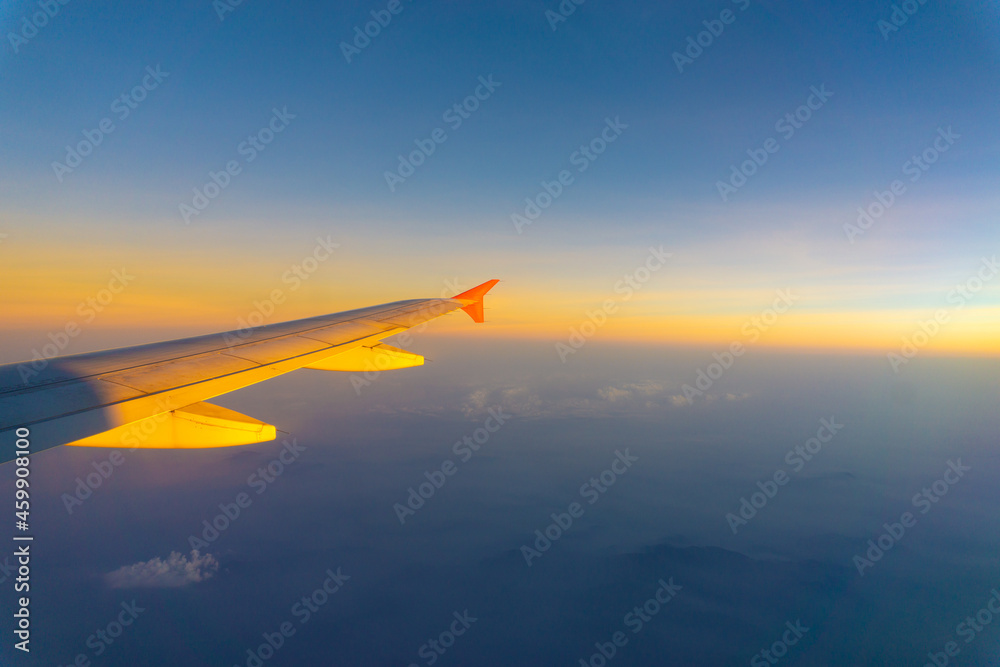 Wing of aircraft on sky with cloud sunset twilight Wing of aircraft on sky with cloud sunset twilight