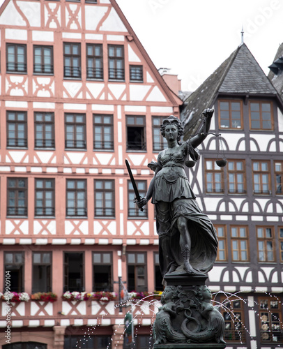 The Justice fountain with half timbered buildings in the background in Romer, Frankfurt, Germany.
