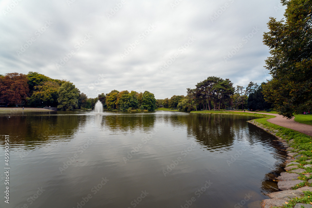 People enjoying the autumn in public park (Kungsparken) in Malmo, Sweden. Ultra Wide Angle View.