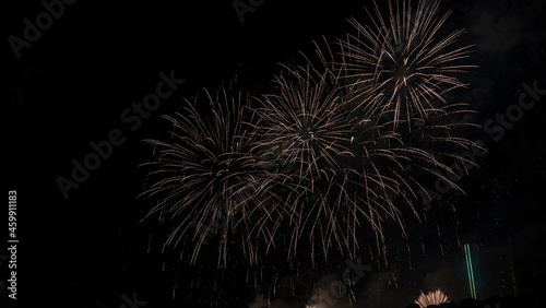 Beautiful colorful holiday fireworks on the black sky background, long exposure. Festive concept.