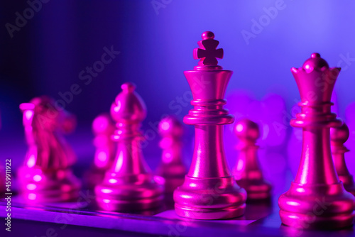 Pink pieces and pawns are on the chessboard.