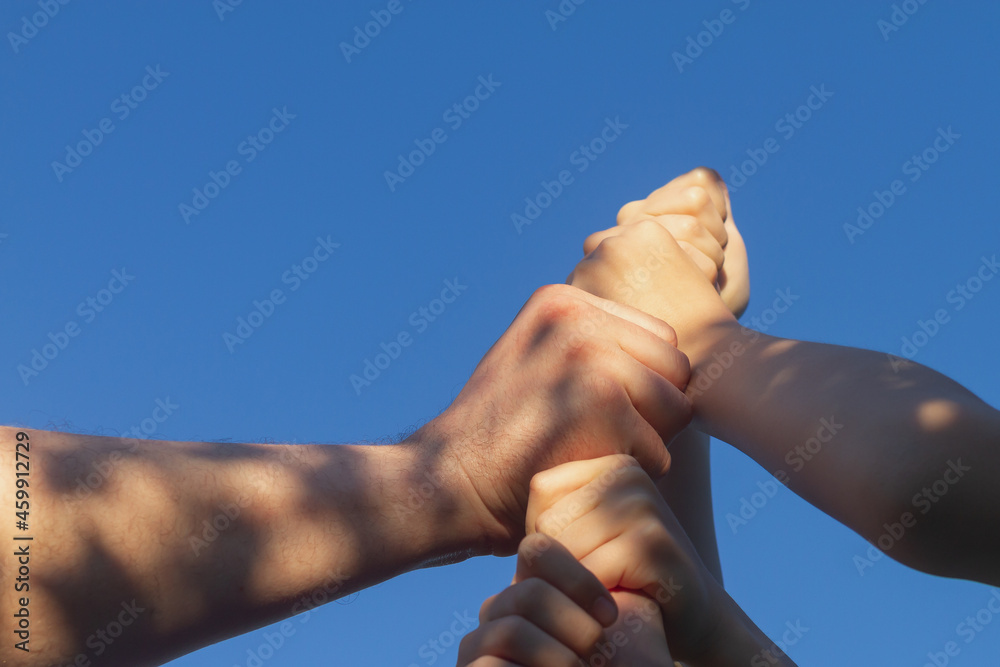 The team of players put their hands together as a sign of unity and support