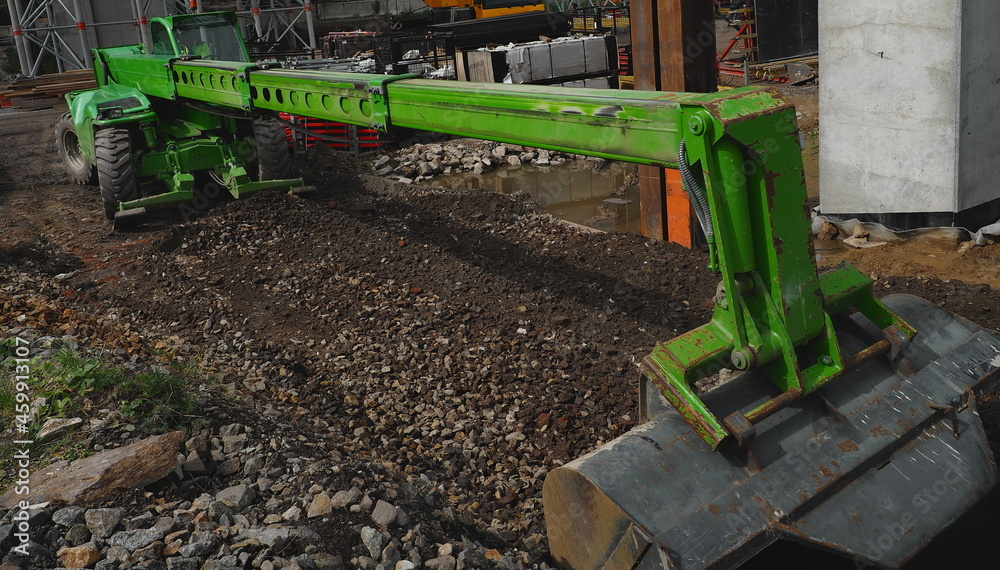 excavator, construction car manita with a bucket at work, green color, clay and construction industry, hydraulic system, long hydraulic hand excavator, construction car manita with a bucket at work, green color, clay and construction industry, hydraulic system, long hydraulic hand