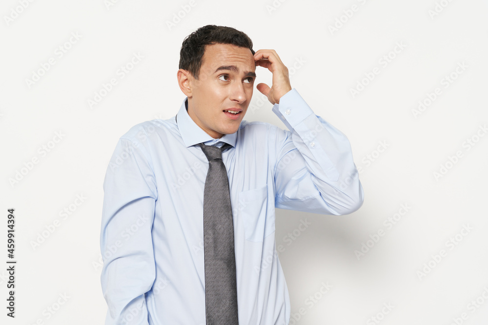 indignant man touches his head with his hand and light shirt tie model indignant man touches his head with his hand and light shirt tie model