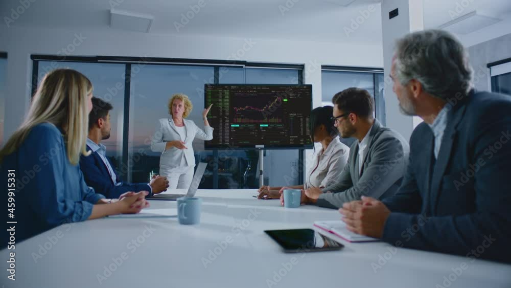 Analysing financial figures and charts at management meeting. Blonde woman leading discussion. Modern open space office interior. Analysing financial figures and charts at management meeting. Blonde woman leading discussion. Modern open space office interior.