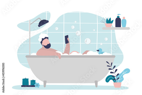 Guy lies in relaxing bath with smartphone. Male character takes bubble bath. Man surfing Internet during spa procedure