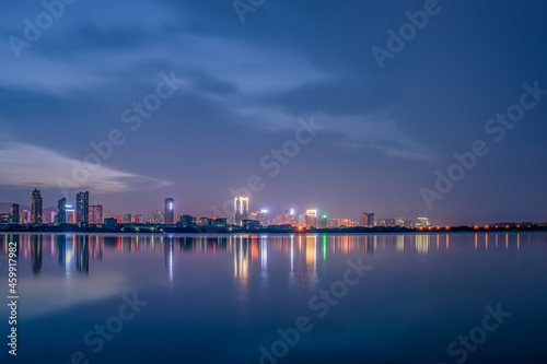 At dusk  the lake reflects the night view of the city