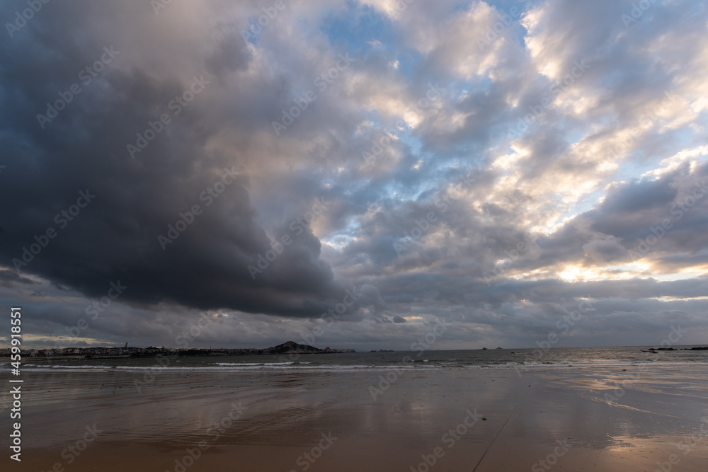 The sky is covered with dark clouds and the beach is cloudy The sky is covered with dark clouds and the beach is cloudy