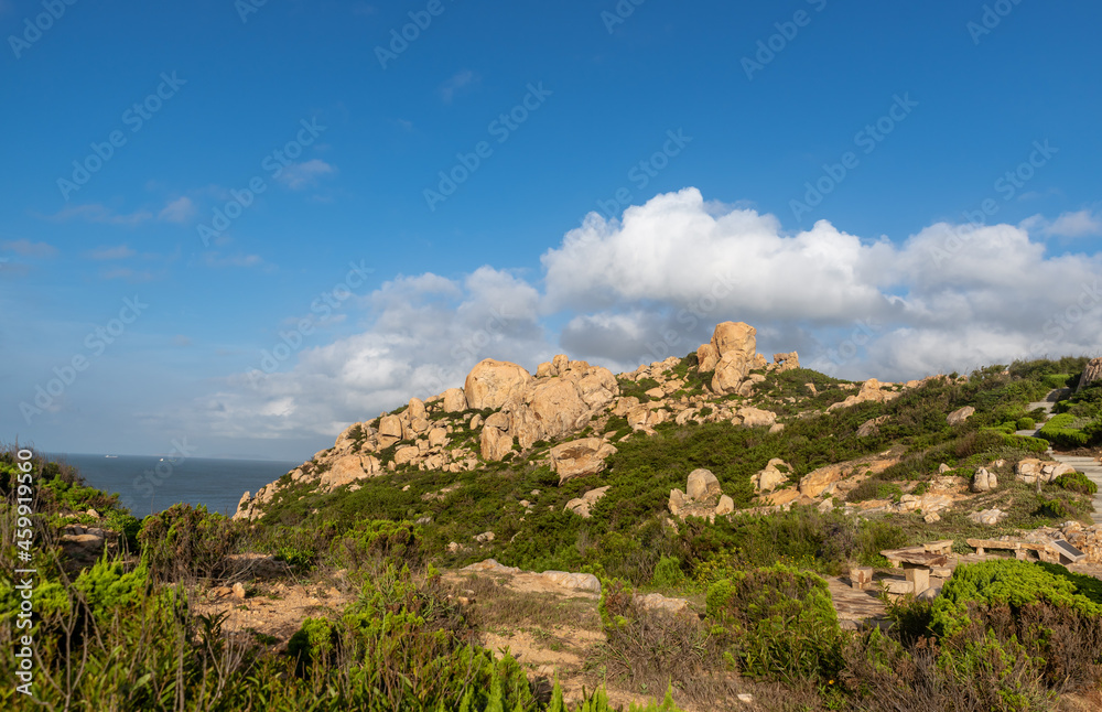 Stones of various shapes weathered by the sea under the blue sky