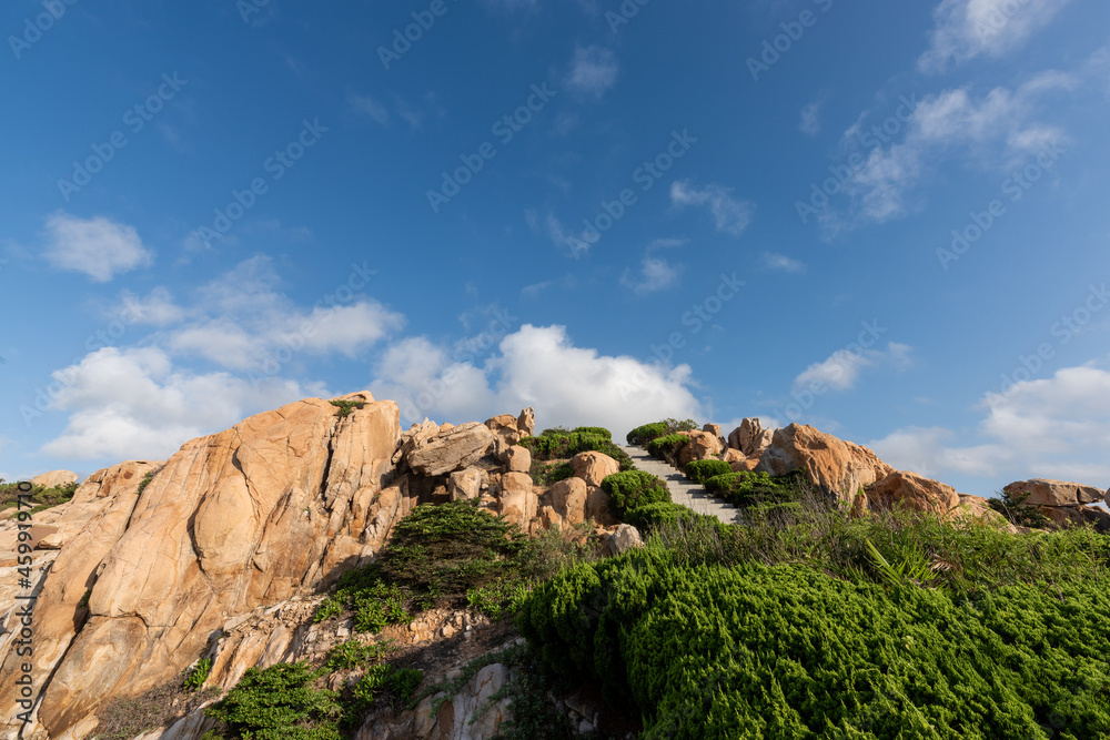 Stones of various shapes weathered by the sea under the blue sky Stones of various shapes weathered by the sea under the blue sky