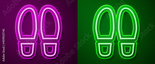 Glowing neon line Footsteps icon isolated on purple and green background. Detective is investigating. To follow in the footsteps. Vector