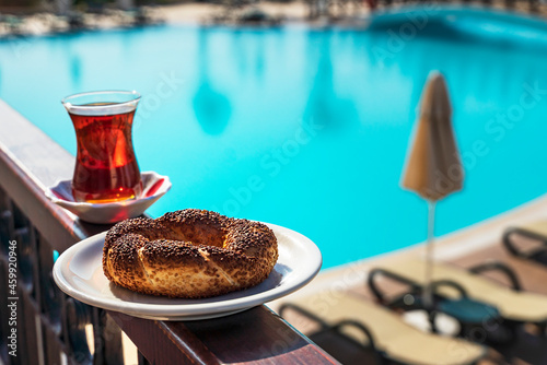 Hot black Turkish tea. and simit, Turkish bagel on a summer background.