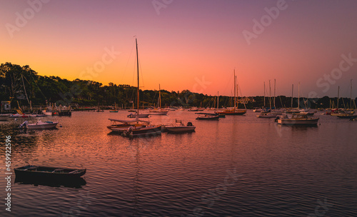 Fototapeta Naklejka Na Ścianę i Meble -  Pink sunrise at the marina with moored boats and yachts on Cape Cod in autumn