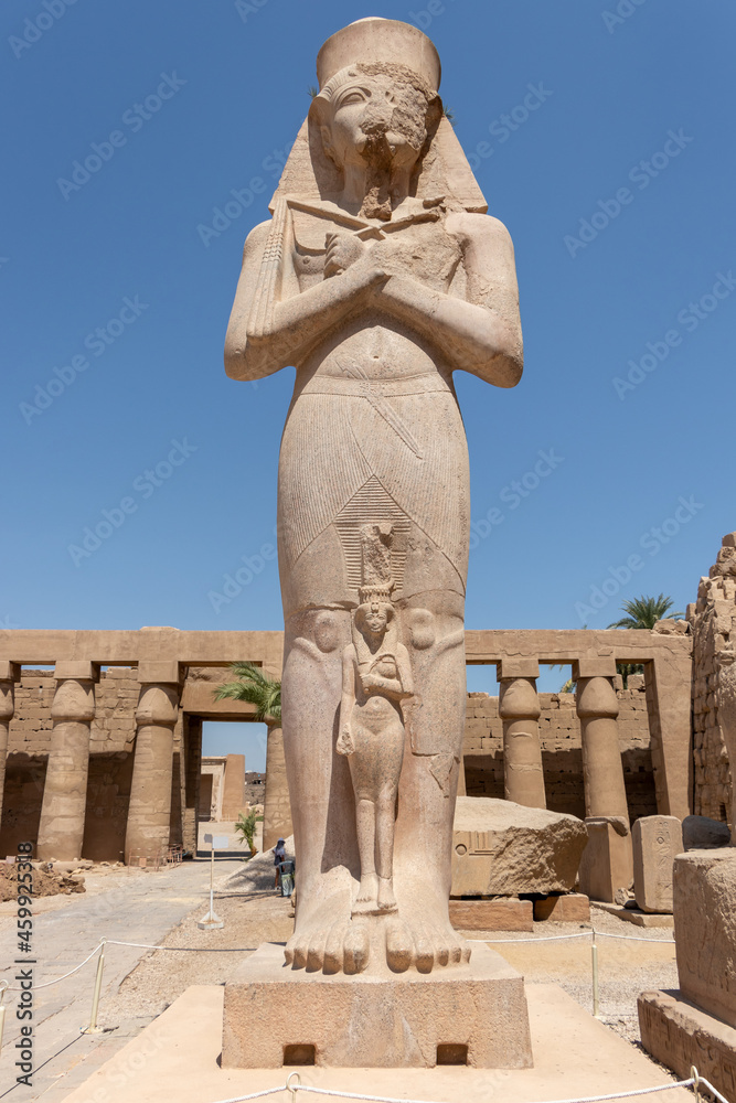 The statue of Ramses II with his daughter Merit-Amon in the temple of Amun-RA in Karnak, Luxor, Egypt.