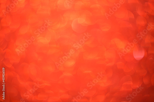 Red bokeh background. Festive Christmas shiny background. Glittering red light.